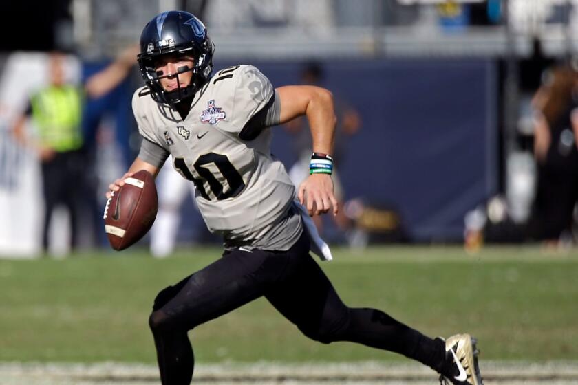 Central Florida quarterback McKenzie Milton scrambles during the second half of the American Athletic Conference championship NCAA college football game against Memphis, Saturday, Dec. 2, 2017, in Orlando, Fla. Central Florida won in overtime 62-55. (AP Photo/John Raoux)