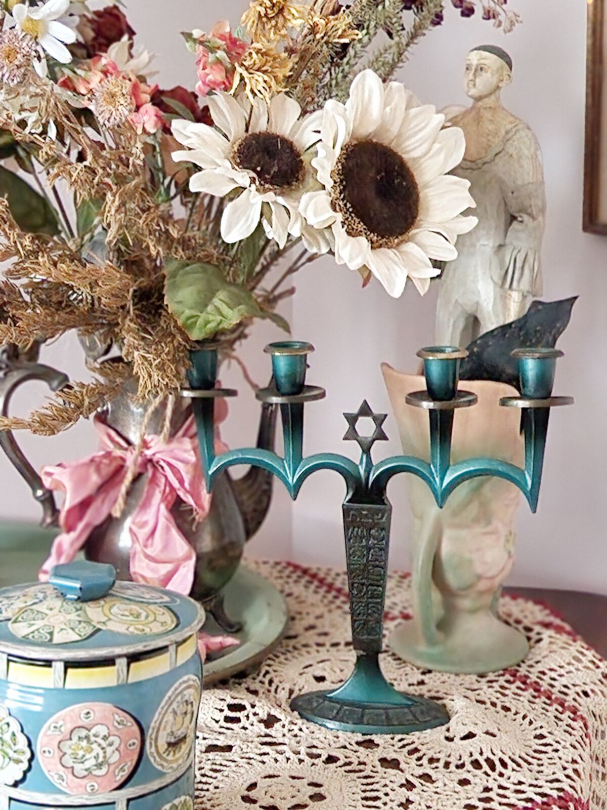 A vintage menorah joins other antique finds by Sheree Perelman in preparation for Hanukkah.