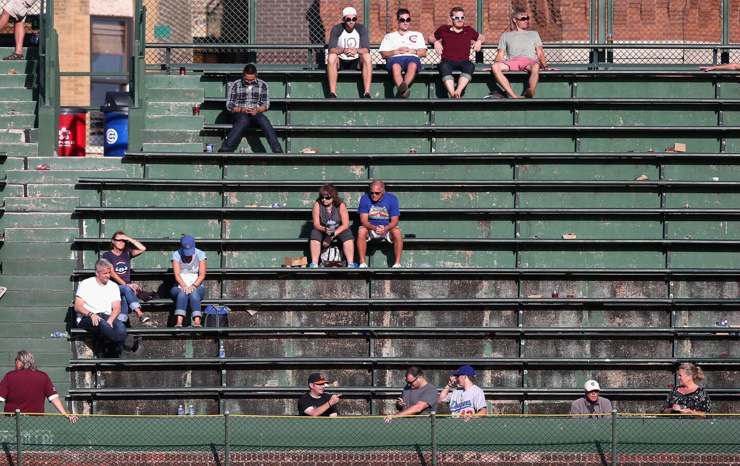 Few fans are left in the right field bleachers in the 9th inning.