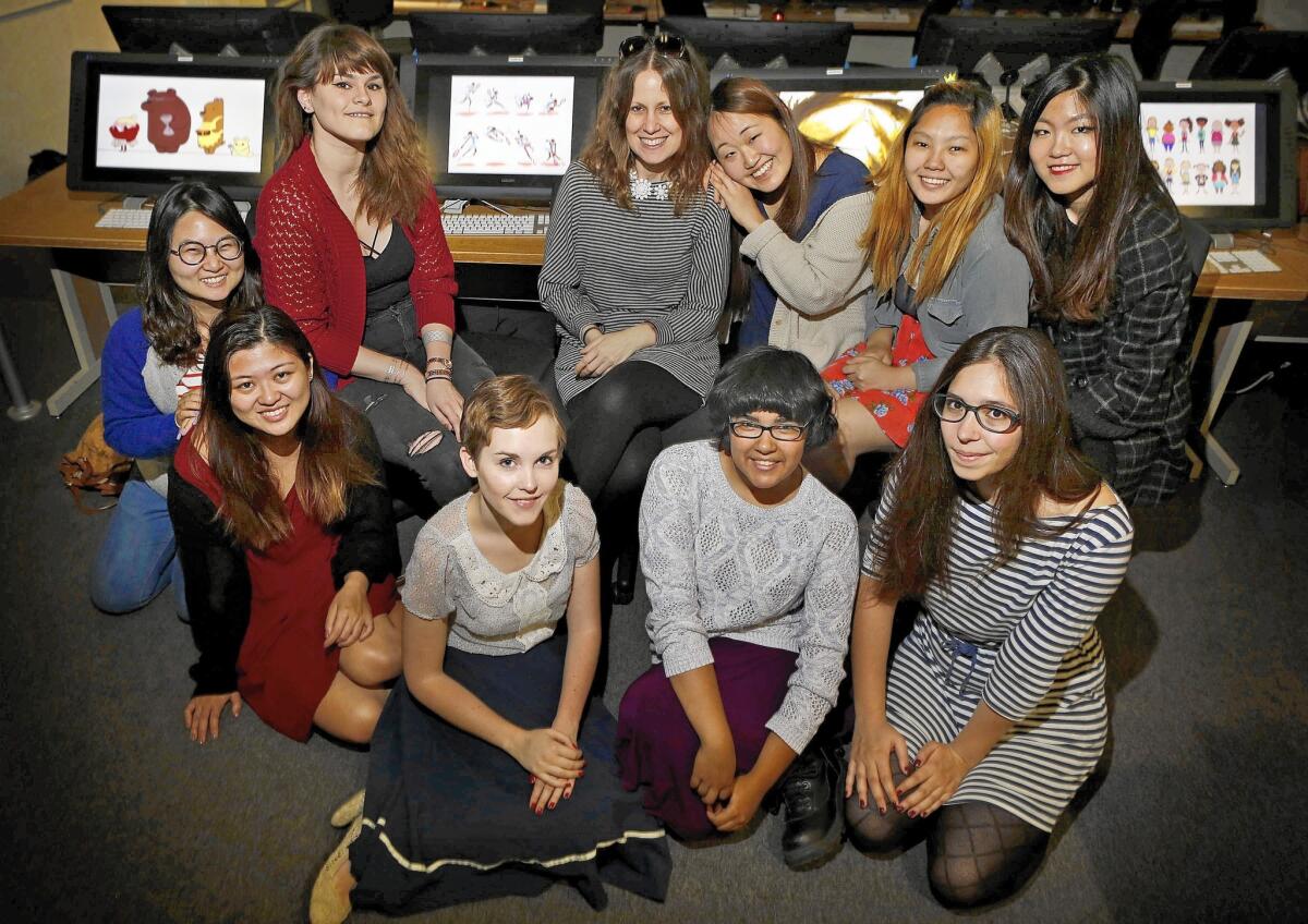 CalArts Animation director Maija Burnett, center, with white flower necklace on, poses with her female students at CalArts, in the Animation Department on May 8, 2015.