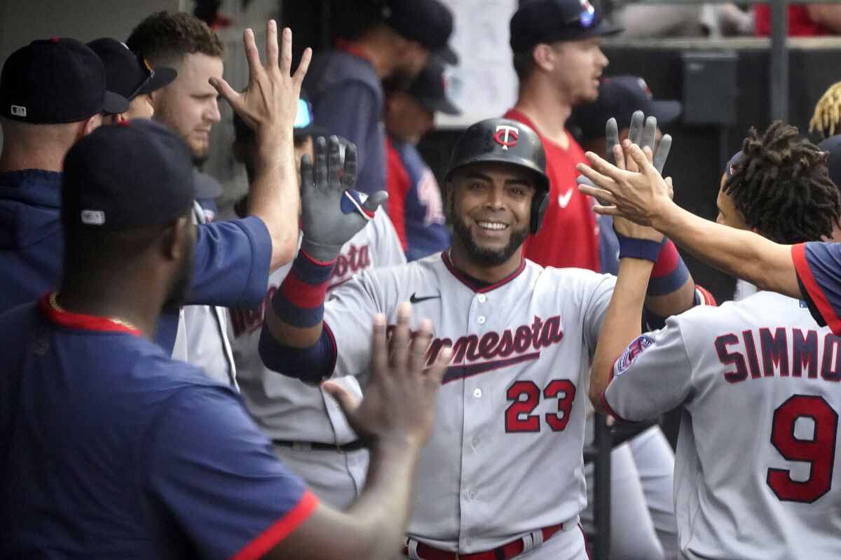 Nelson Cruz celebrates with Twins teammates after a home run 