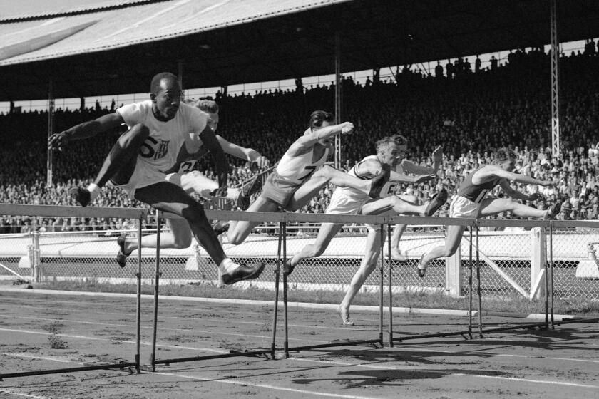 FILE - In this June 1949 photo, competitors jump in the 120-yard international hurdles during the British Games, incorporating International Athletics Match, in London. The competitors are P Van de Sype of Belgium (1); A. Marie of France (no.3); Donald Finlay of Britain (4); E. Arneberg, of Norway (5); Harrison Dillard, left, of the United States, and G. V. D. Hoeven, of Holland (7). Dillard won the event in 14.4 seconds, followed by A. Marie in second place and Finlay in third. Dillard, the only Olympic runner to win gold medals in both the sprints and high hurdles, has died. He was 96. Longtime friend Ted Theodore said Dillard died Friday, Nov. 15, 2019, at the Cleveland Clinic after a fight with stomach cancer. The 1955 Sullivan Award winner as the nation's outstanding amateur athlete, Dillard was the oldest living U.S. Olympic champion. (AP Photo, File)