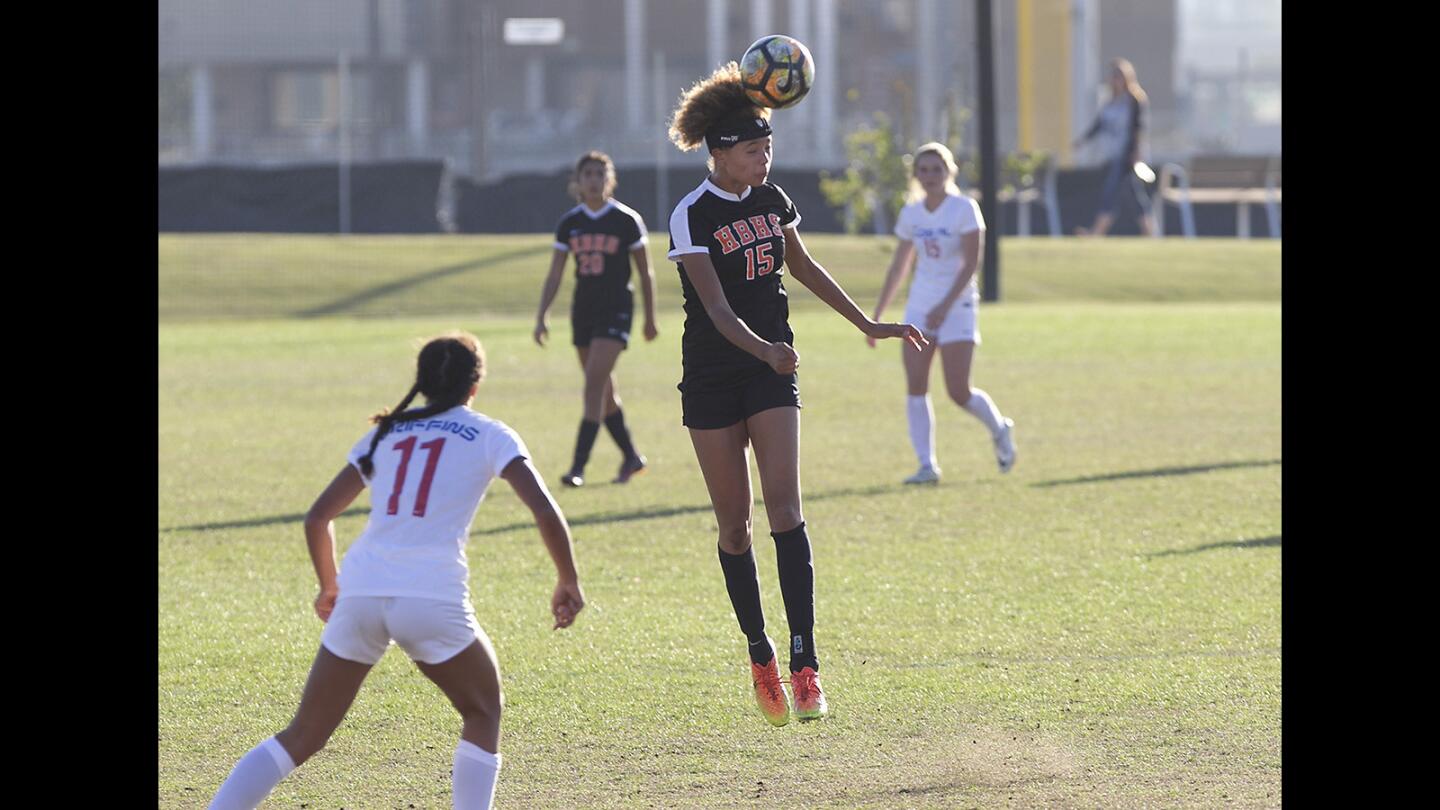 Huntington's Xolani Hodel, heads the ball against Los Alamitos during the Mater Dei Premier Invitational tournament at Orange County Great Park in Irvine.