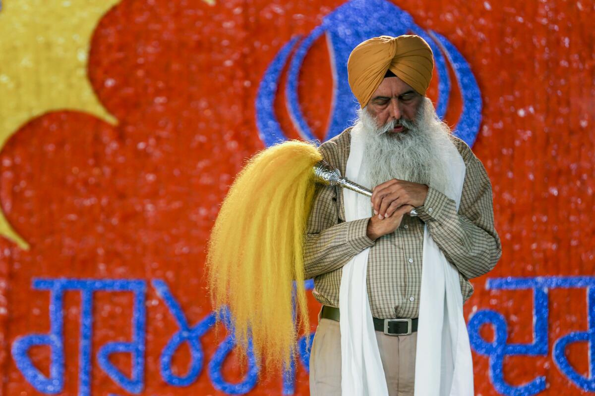 A Sikh priest offer prayers during Nagar Kirtan services at Gurdwara Guru Angad Darbar in Bakersfield. (Irfan Khan / Los Angeles Times)