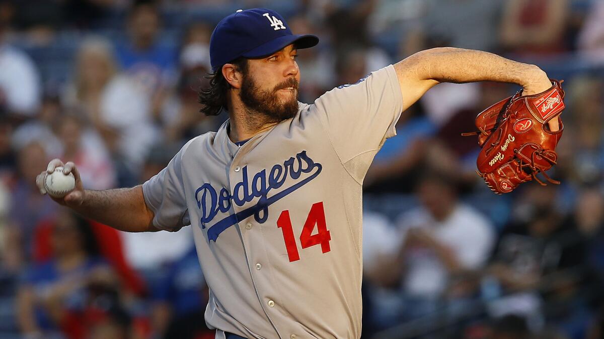 Dodgers starter Dan Haren delivers a pitch in the second inning against the Atlanta Braves on Tuesday.