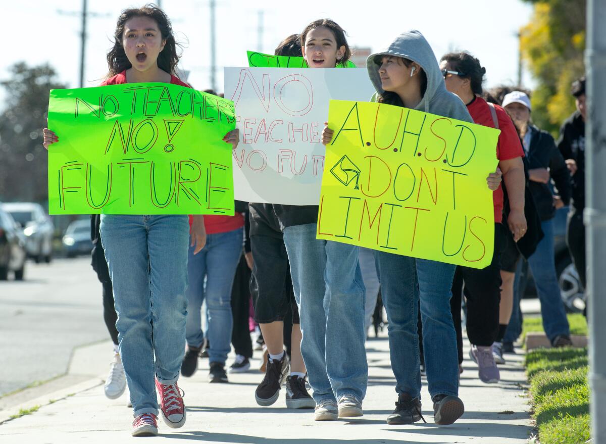 Students lead parents in a march against planned teacher layoffs within the Anaheim Union High School District.