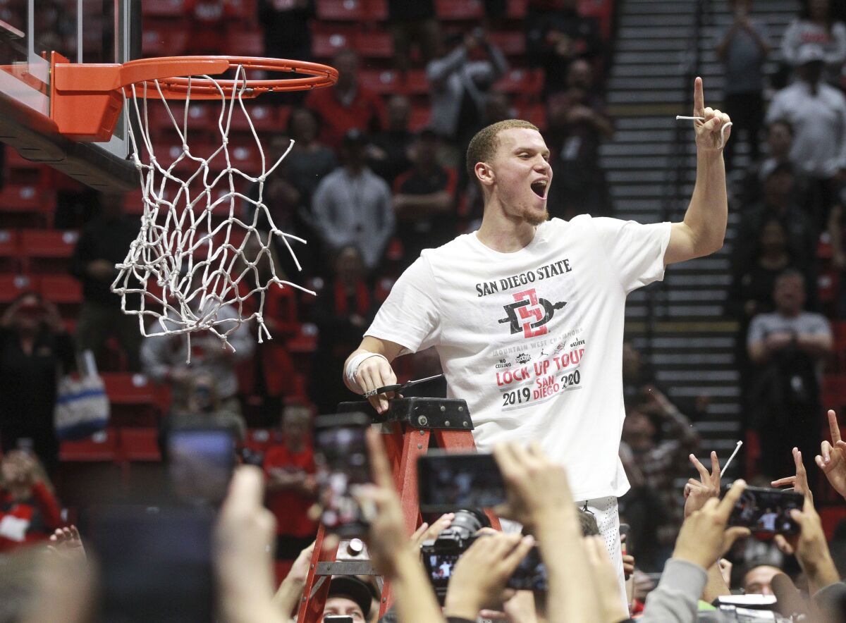 SDSU's Malachi Flynn cuts down the net at Viejas Arena after Aztecs clinched Mountain West conference championship last month.