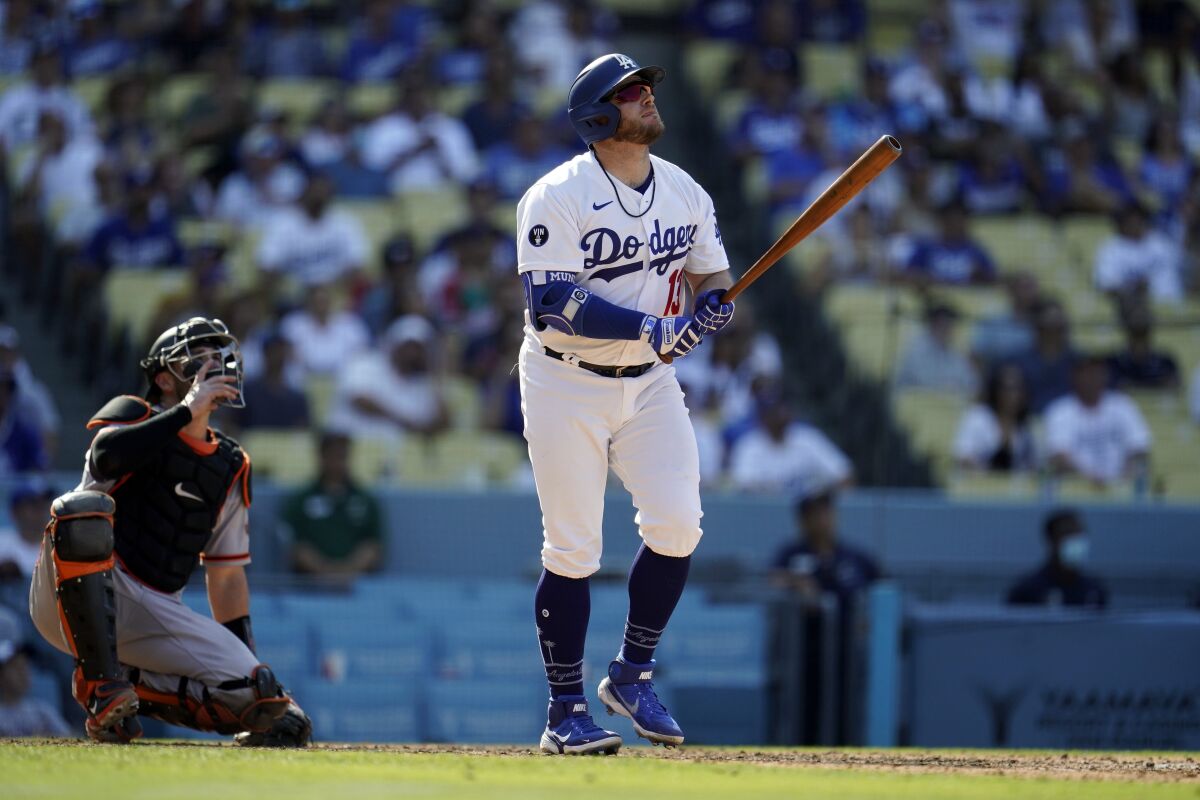 Dodgers' Max Muncy looks at his triple home run.