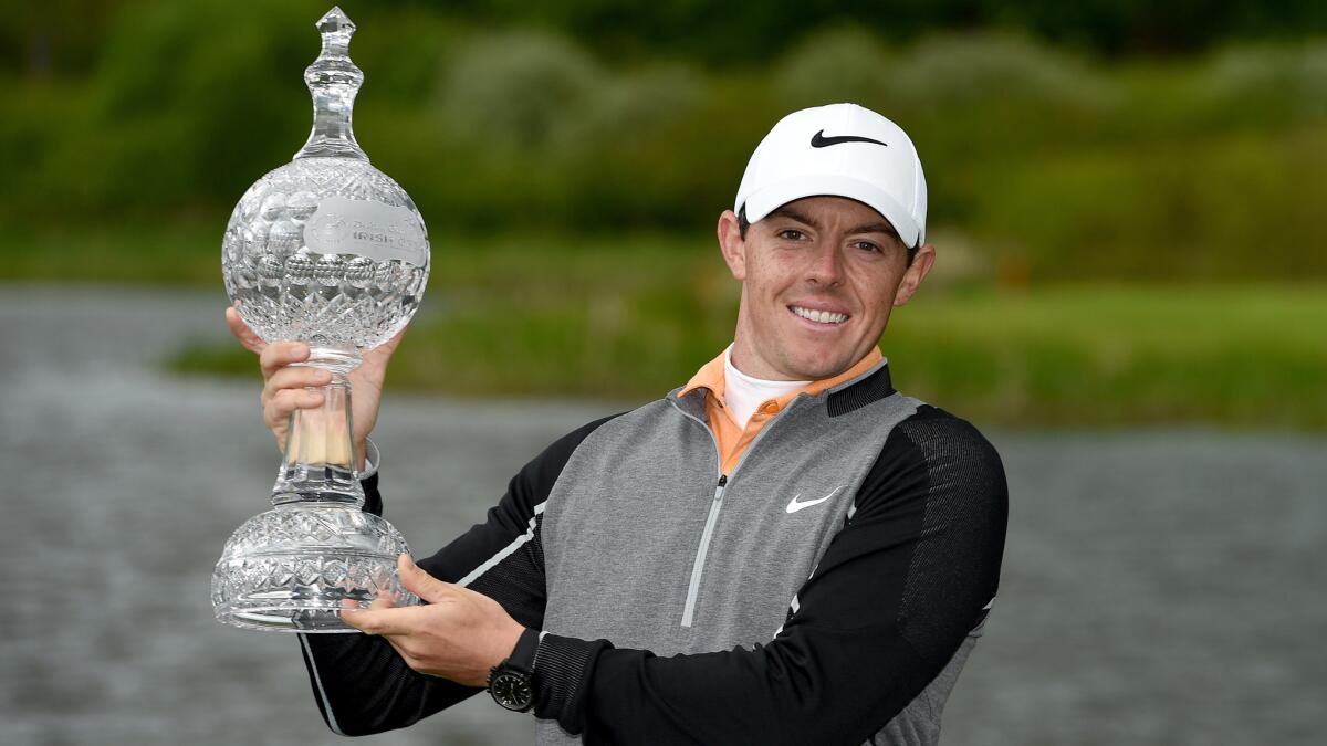 Rory McIlroy hoists the winner's trophy after claiming victory in the Irish Open on Sunday.