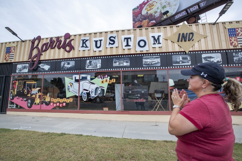 Joji Barris-Paster se tient devant l'entrée principale de Barris Kustom Industries à North Hollywood.