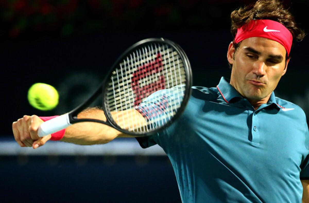 Roger Federer hits his patented backhand against Tomas Berdych in the Dubai Championships final on Sunday.