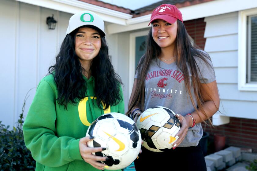 Marina High School senior soccer teammates Kaitlyn Paculba, left, and McKenna Pua, right, have committed to Oregon and Washington State, respectively, at home in Huntington Beach on Wednesday, Nov. 11, 2020.