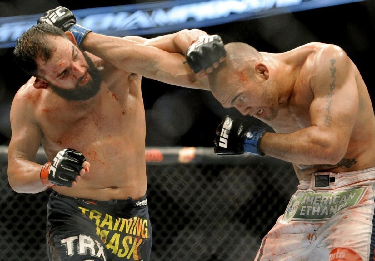 Johny Hendricks, left, tangles with Robbie Lawler.