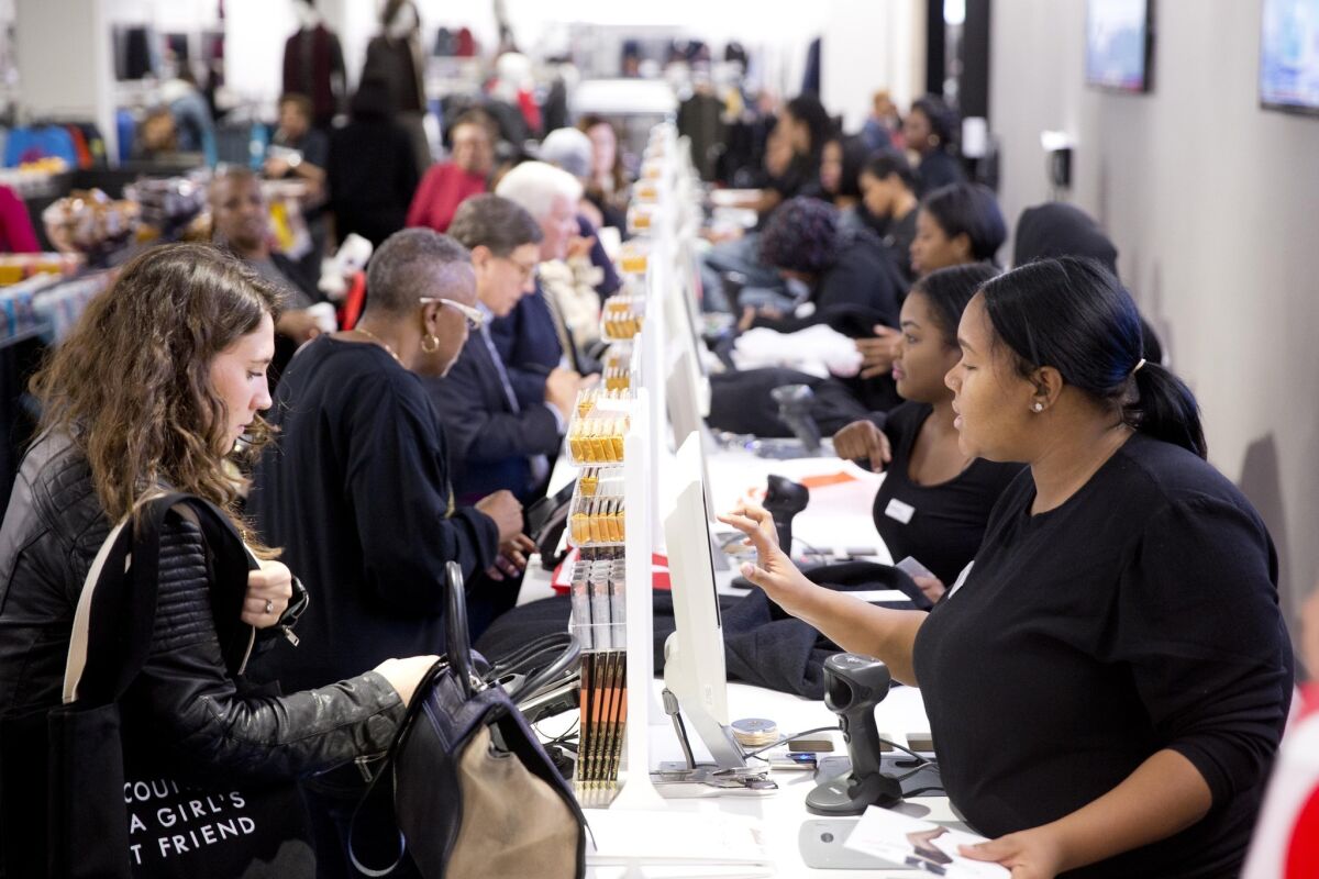 Customers pay for purchases at the Century 21 department store in Philadelphia on Oct . 28.