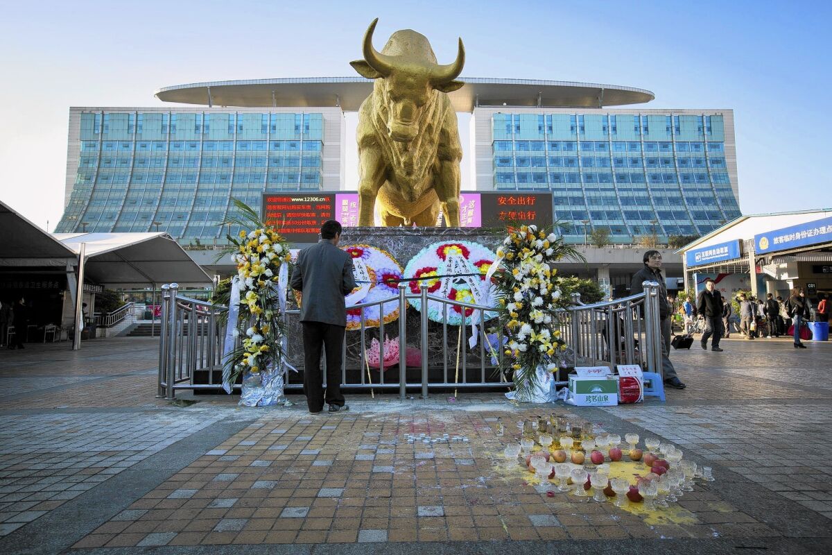 Sympathy messages on wreaths are left outside the Kunming Railway Station, where black-clad attackers with knives hacked through crowds, killing 29 and injuring more than 140. The Chinese government has said little about the case.
