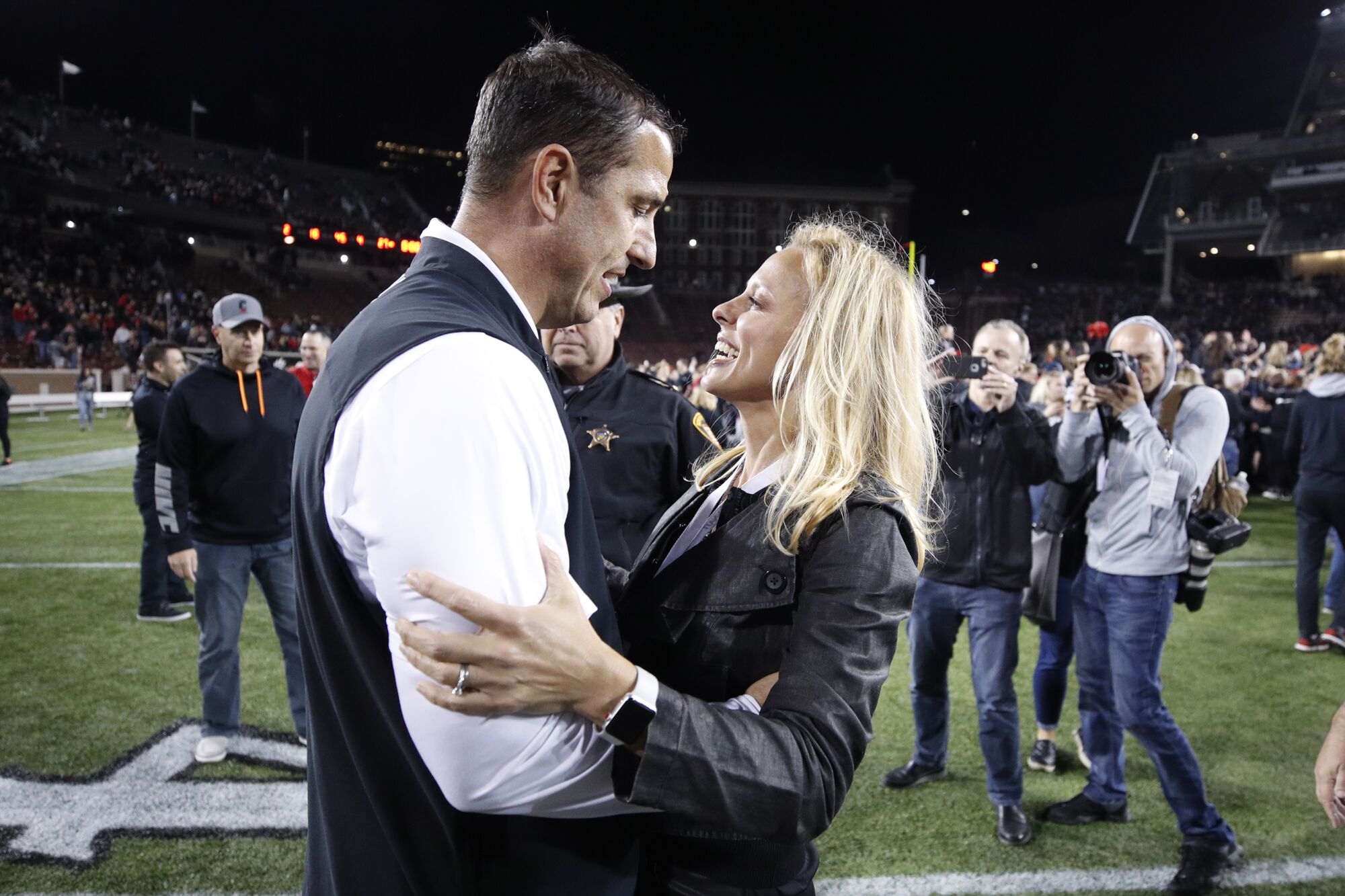 Cincinnati coach Luke Fickell celebrates with his wife, Amy, after the game beating UCF at Nippert Stadium 
