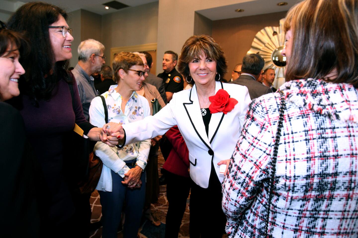 Glendale Mayor Paula Devine, center, greets attendees before delivering her State of the City address.
