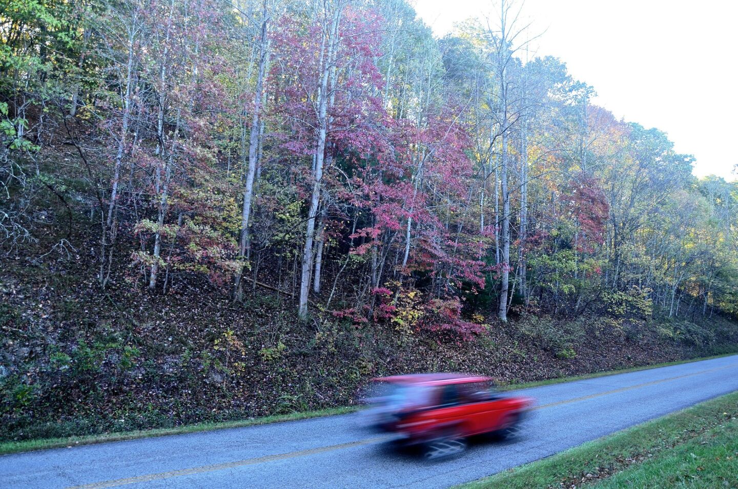 A red sports car zips past the outskirts of Roanoke, Va., on Oct 21.