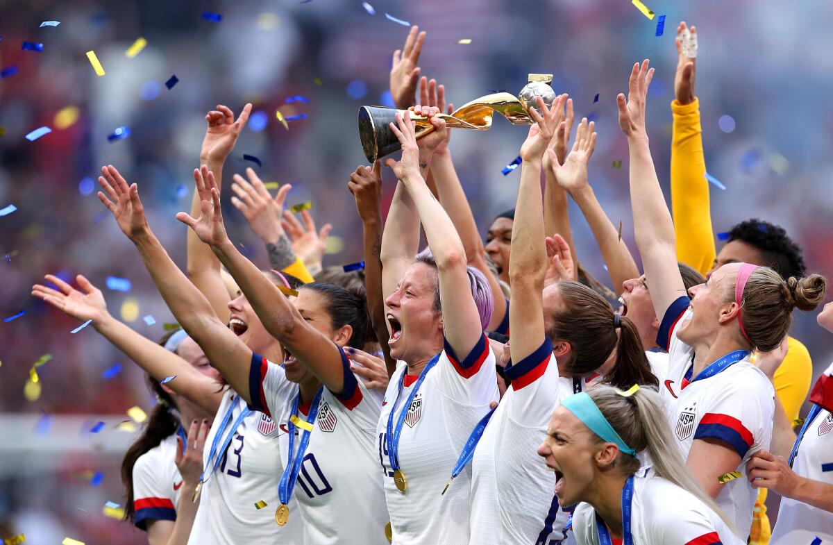 Megan Rapinoe of the USA lifts the FIFA Women's World Cup Trophy following her team's victory in the 2019 FIFA Women's World Cup France Final match between The United States of America and The Netherlands at Stade de Lyon on July 07, 2019 in Lyon, France.