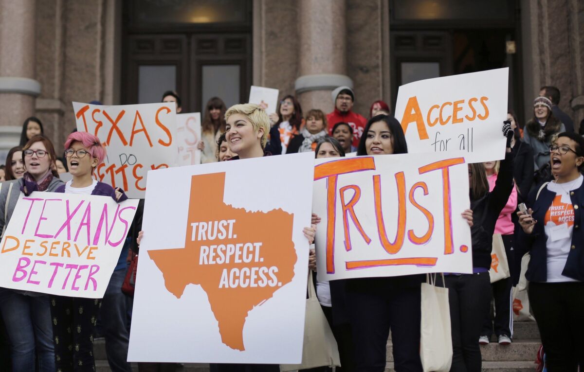 College students and abortion rights activists hold signs during a rally on the steps of the Texas Capitol, in Austin, Texas last February. On June 29, the Supreme Court refused on to allow Texas to enforce restrictions that would force 10 abortion clinics to close.