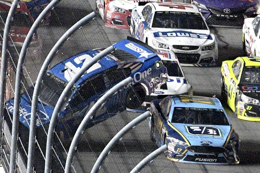 Kyle Larson (42) hits the wall on the front stretch as Ricky Stenhouse Jr. (17) passes underneath during the NASCAR Cup auto race in Daytona Beach, Fla., Saturday, July 1, 2017. (AP Photo/Phelan M. Ebenhack)