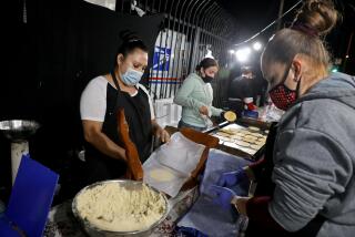 LOS ANGELES, CA - JULY 29: Antonia Arizpe, from left, Yeroslava Guerrero, and Cristina Ramirez, prepare handmade tortillas at Tacos a Cabron (cq) along Atlantic Blvd. in East Los Angeles on Wednesday, July 29, 2020 in Los Angeles, CA. 24-hours in the life of Latinos during COVID-19 pandemic. (Gary Coronado / Los Angeles Times)