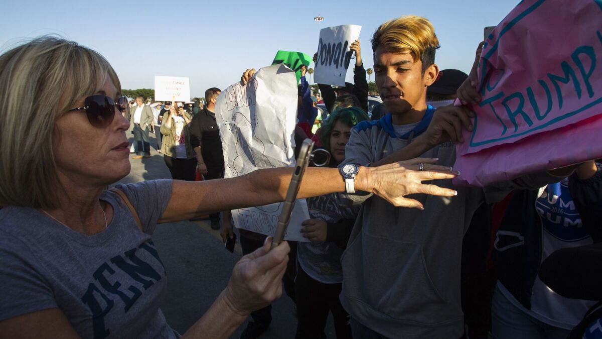 Supporters and opponents of then-presidential candidate Donald Trump confront one another outside a Trump rally in Costa Mesa in April 2016.