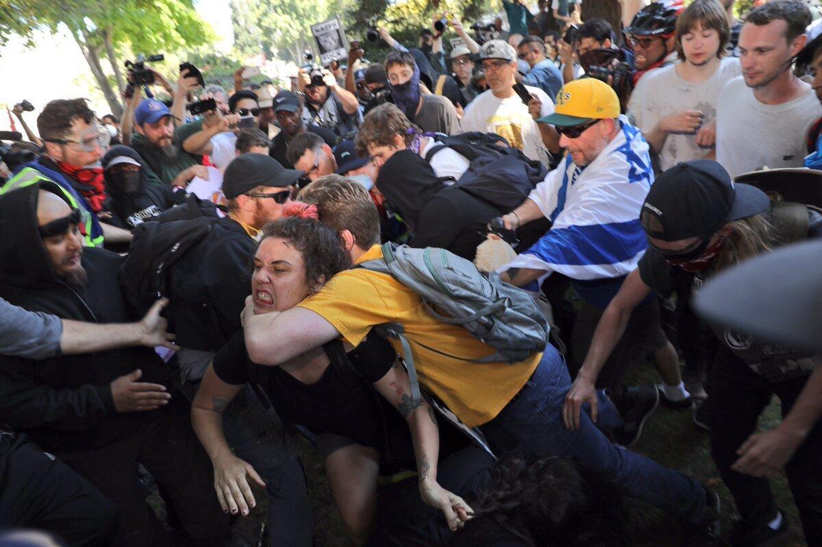 A fight breaks out during Berkeley protests several weeks ago. The city and university have planned a large police presence and other security measures for a conservative writer's talk this week.
