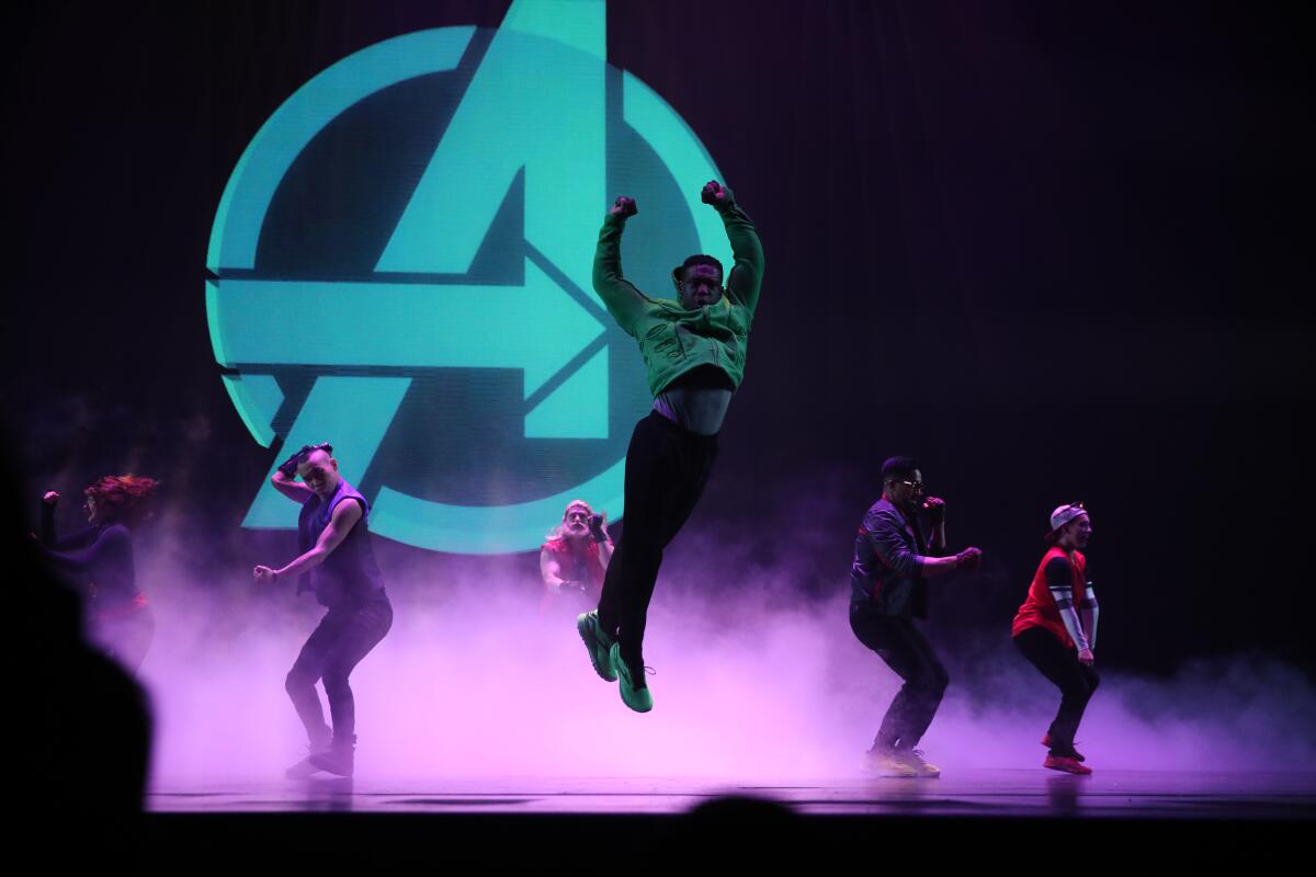 Actors dance and leap onstage as the Avengers in Disney California Adventure's "Rogers: The Musical."