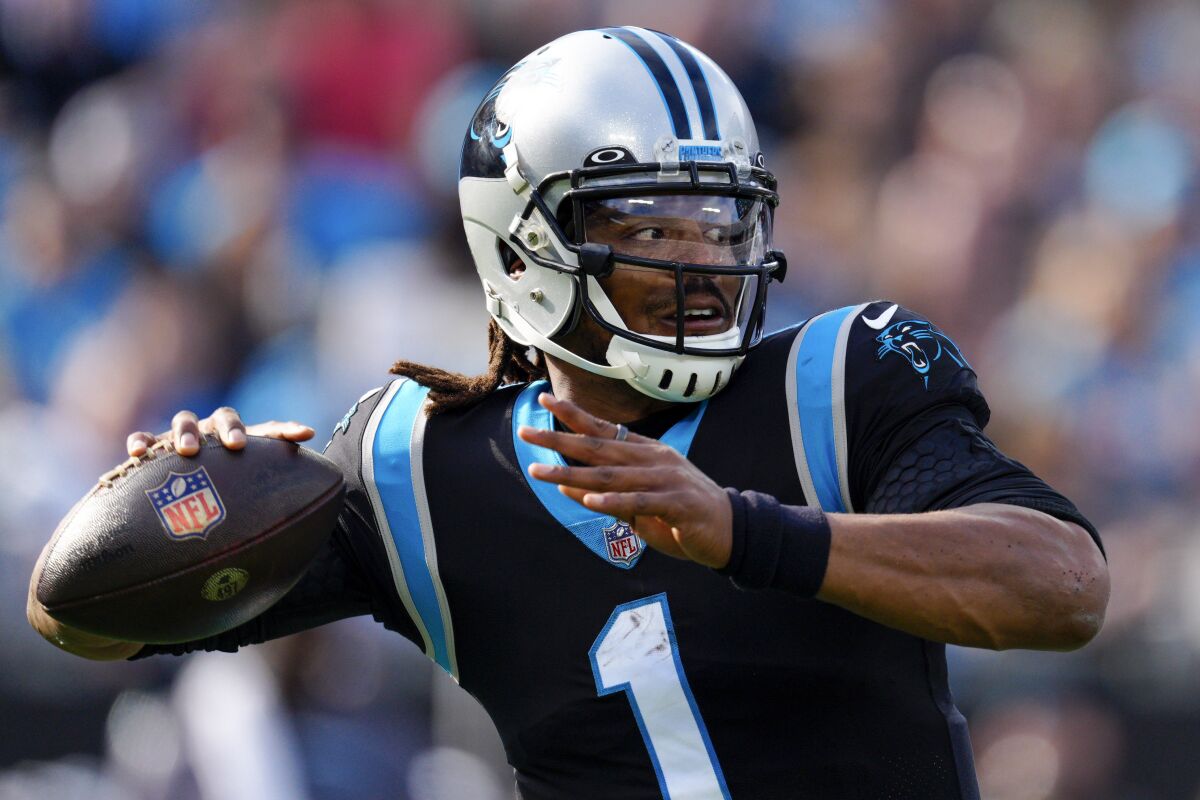 FILE - Carolina Panthers quarterback Cam Newton passes against the Tampa Bay Buccaneers during the first half of an NFL football game on Dec. 26, 2021, in Charlotte, N.C. Newton, who still considers himself one of the top 32 quarterbacks in the NFL and remains an unrestricted free agent, said people’s perception of him has changed largely because he put himself in bad situations the past two years with the Carolina Panthers and New England Patriots. (AP Photo/Jacob Kupferman, File)