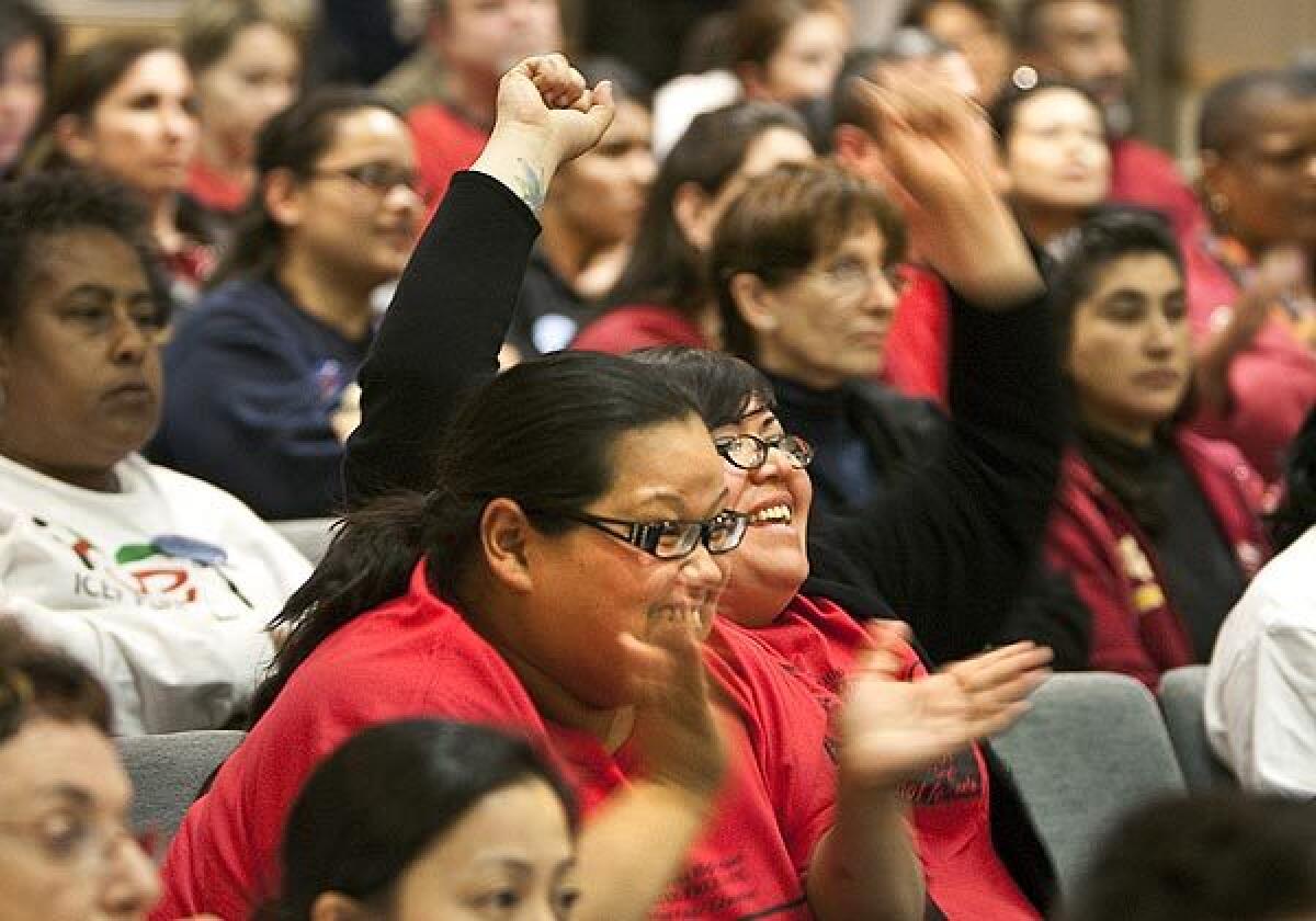 Audience members react as the L.A. Unified Board of Education decides how to divvy up 30 campuses Tuesday. The board decided not to turn over schools to three leading charter school operators.