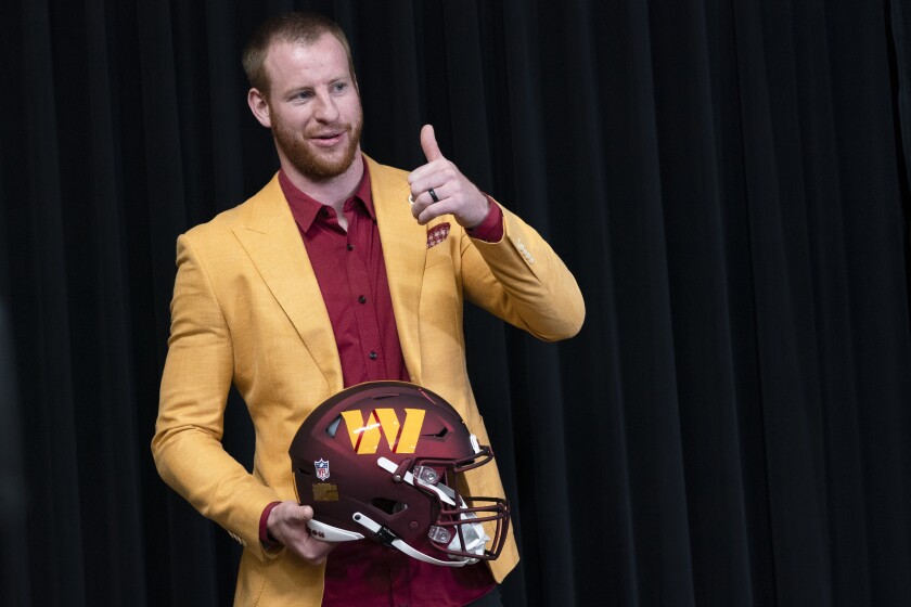 Washington Commanders m new quarterback Carson Wentz gives thumbs-up during his introductory news conference.