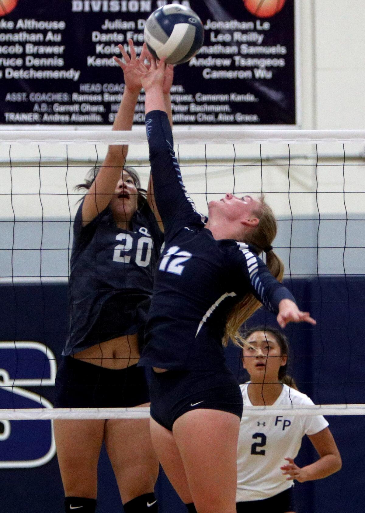 Flintridge Prep girls' volleyball player #20 Kaitlyn Chen goes for the block on #12 Stephanie Norberg in game vs. Chadwick, at home in La Canada Flintridge on Tuesday, Oct. 1, 2019.