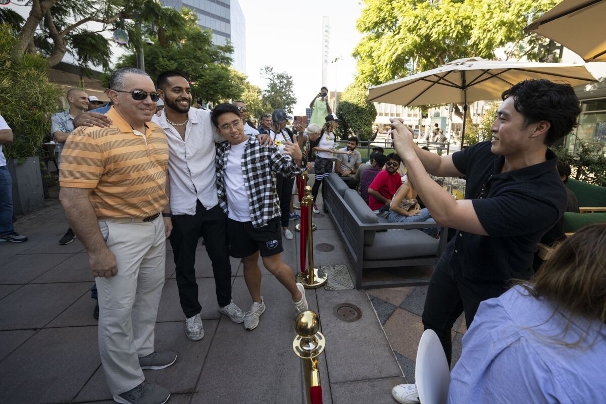 Los Angeles County Sheriff Alex Villanueva poses for a photo with people dining at a restaurant in Santa Monica