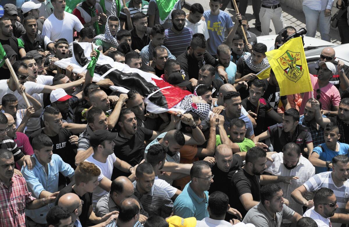 Mourners near Ramallah carry the body of Laith Khalidi, 17, who was killed during clashes with Israeli troops.