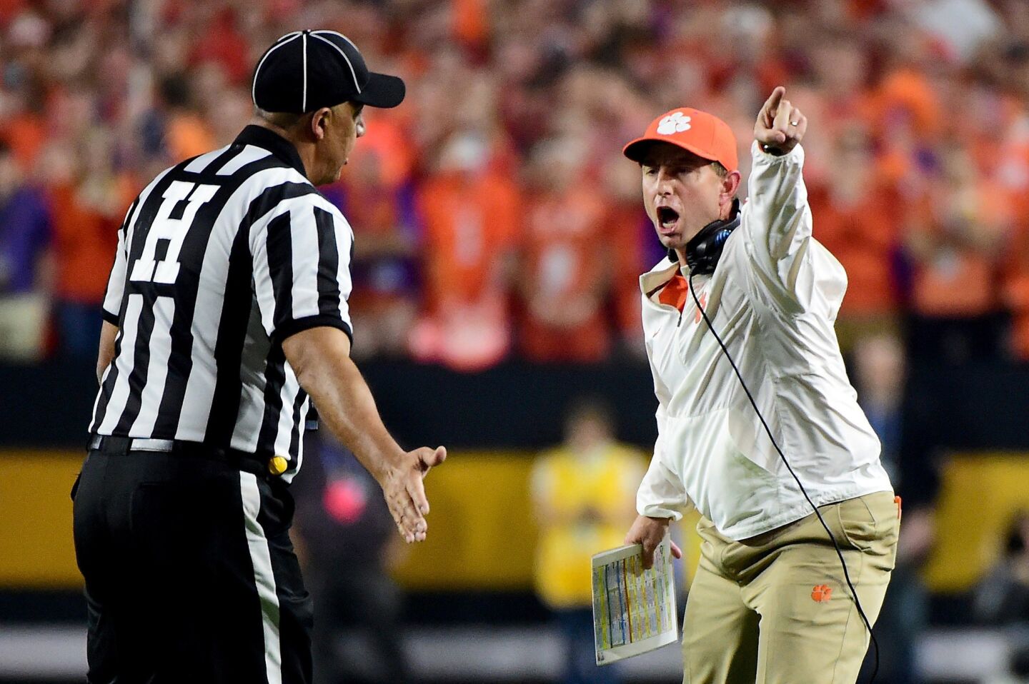 Clemson Coach Dabo Swinney argues a call with the referees during the first half.