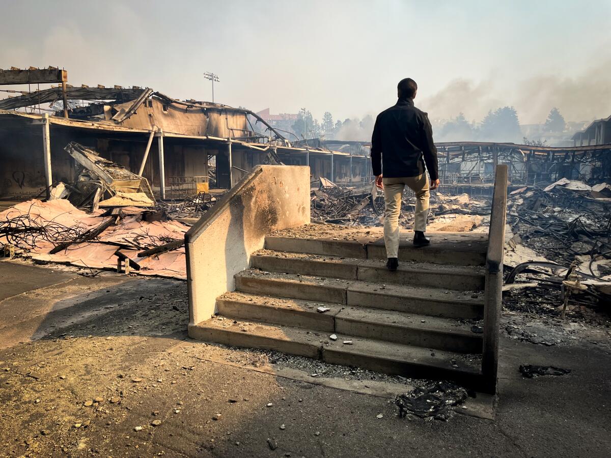 L.A. schools Supt. Alberto Carvalho inspects fire damage at in Pacific Palisades.
