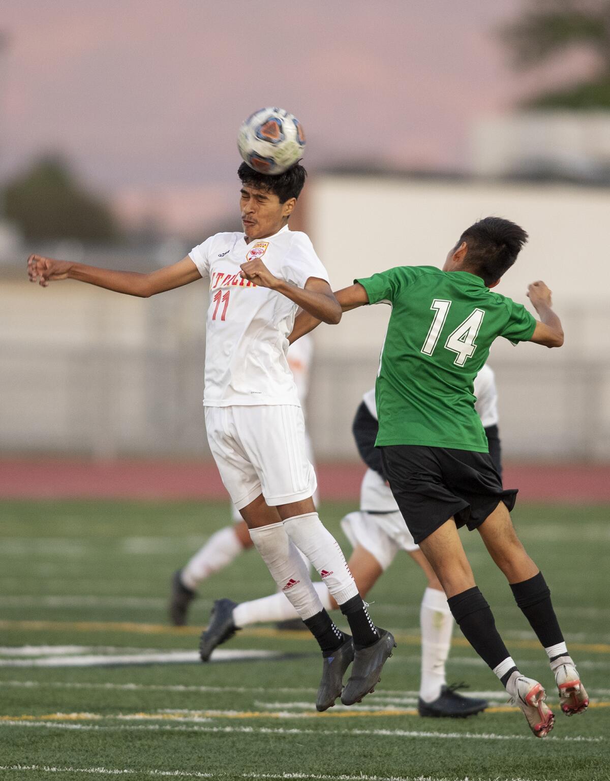 Estancia's Kevin Flores goes up for a header against Costa Mesa's Kevin Perez Cruz on Wednesday.