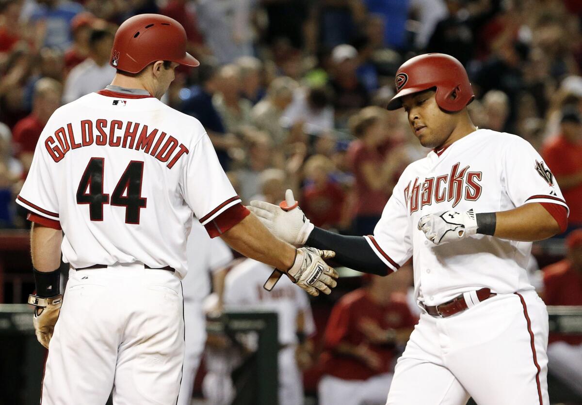 Diamondbacks outfielder Yasmany Tomas is congratulated by Paul Goldschmidt after hitting a two-run home run against the Dodgers.