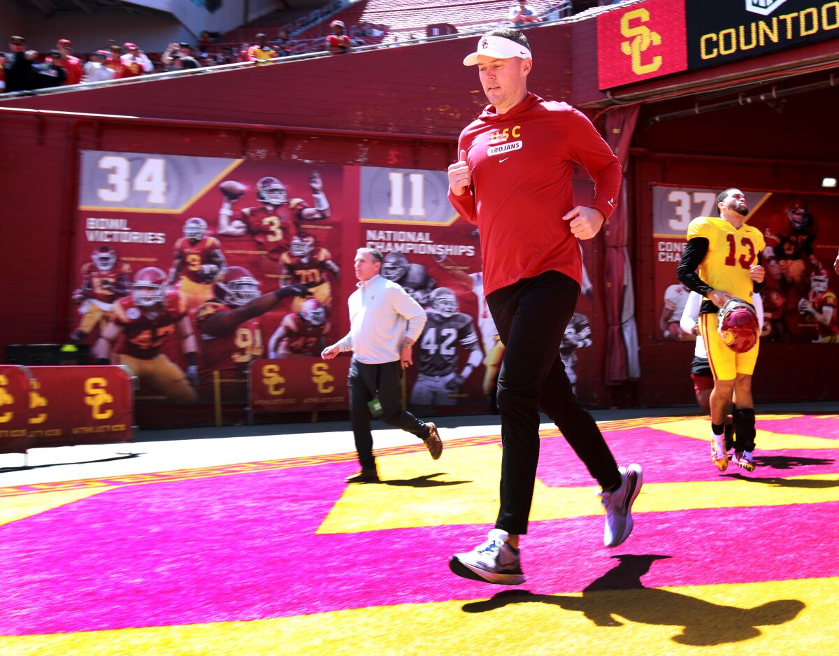 USC coach Lincoln Riley walks onto the field ahead of the Trojans' spring game at the Coliseum in April.