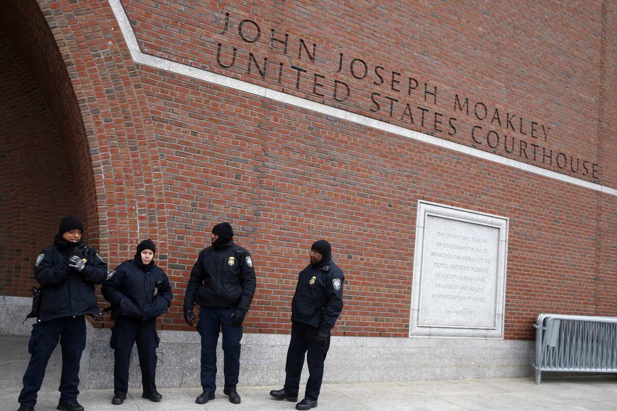 Police stand outside the federal courthouse in Boston.