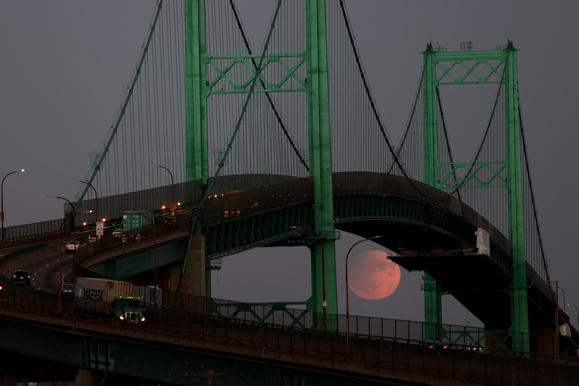 The moon is seen over the Vincent Thomas Bridge in San Pedro on Tuesday night.