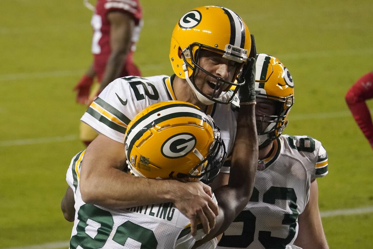 Green Bay Packers wide receiver Marquez Valdes-Scantling, bottom left, and quarterback Aaron Rodgers (12) celebrate after connecting on a touchdown pass during the second half of an NFL football game against the San Francisco 49ers in Santa Clara, Calif., Thursday, Nov. 5, 2020. (AP Photo/Tony Avelar)