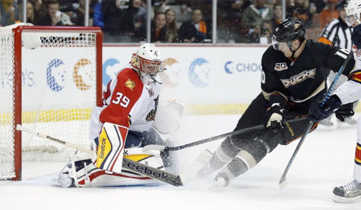 Florida goalie Dan Ellis makes a save as Corey Perry sprays him with ice during the Ducks' 6-2 win Sunday over the Panthers at the Honda Center.