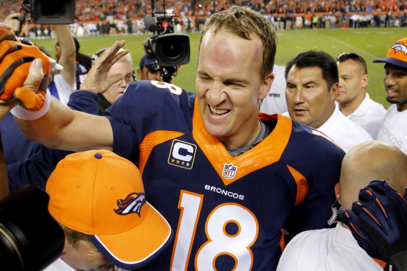 In Sunday's victory over the San Francisco 49ers, Denver Broncos quarterback Peyton Manning celebrates with teammates and members of the team staff after breaking the record for most career touchdown passes.