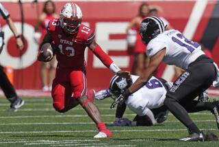 Utah quarterback Nate Johnson (13) carries the ball as Weber State safety Koa Hansen.