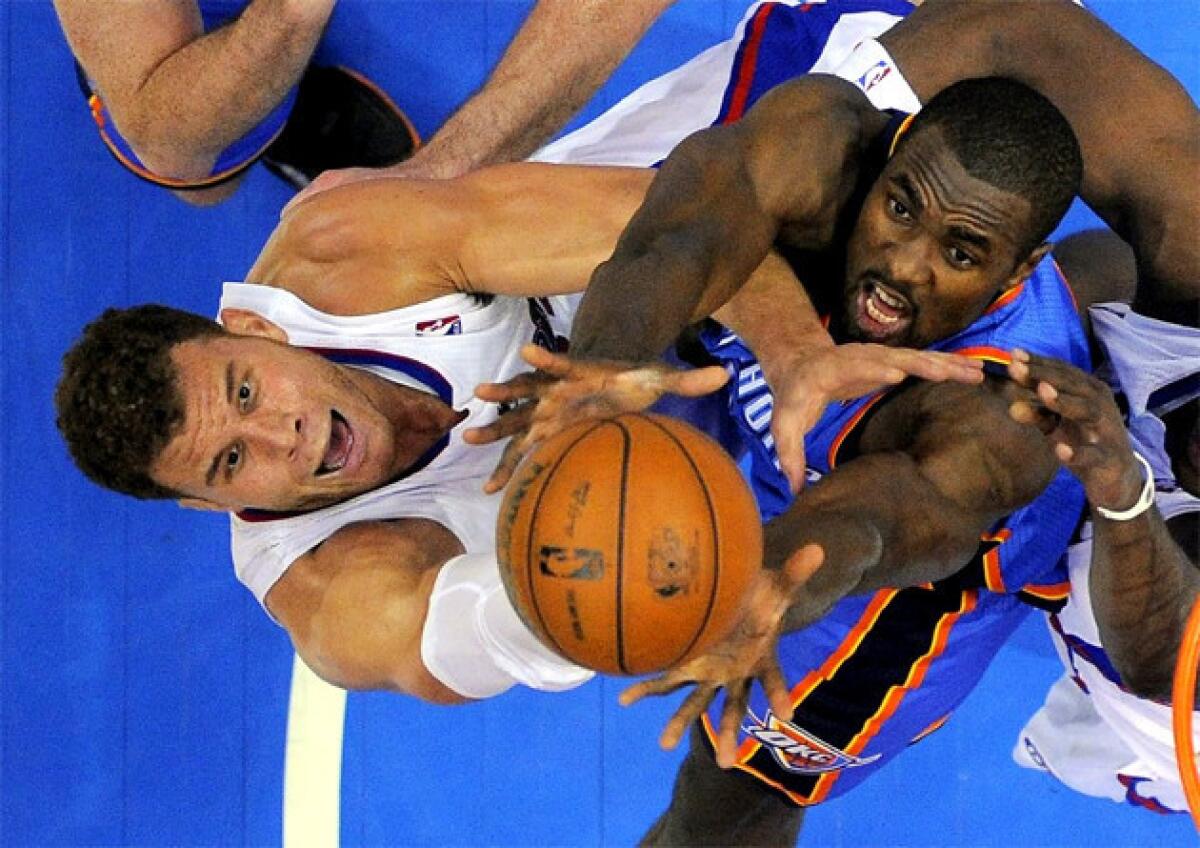 Clippers forward Blake Griffin, left, and Oklahoma City Thunder forward Serge Ibaka battle for a rebound.