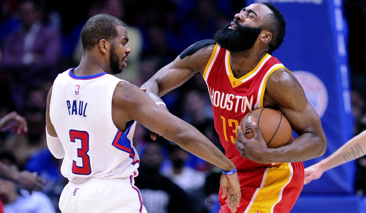 Clippers point guard Chris Paul (3) tries to steal the ball from Rockets guard James Harden in the first half of Game 3 on Friday night at Staples Center.