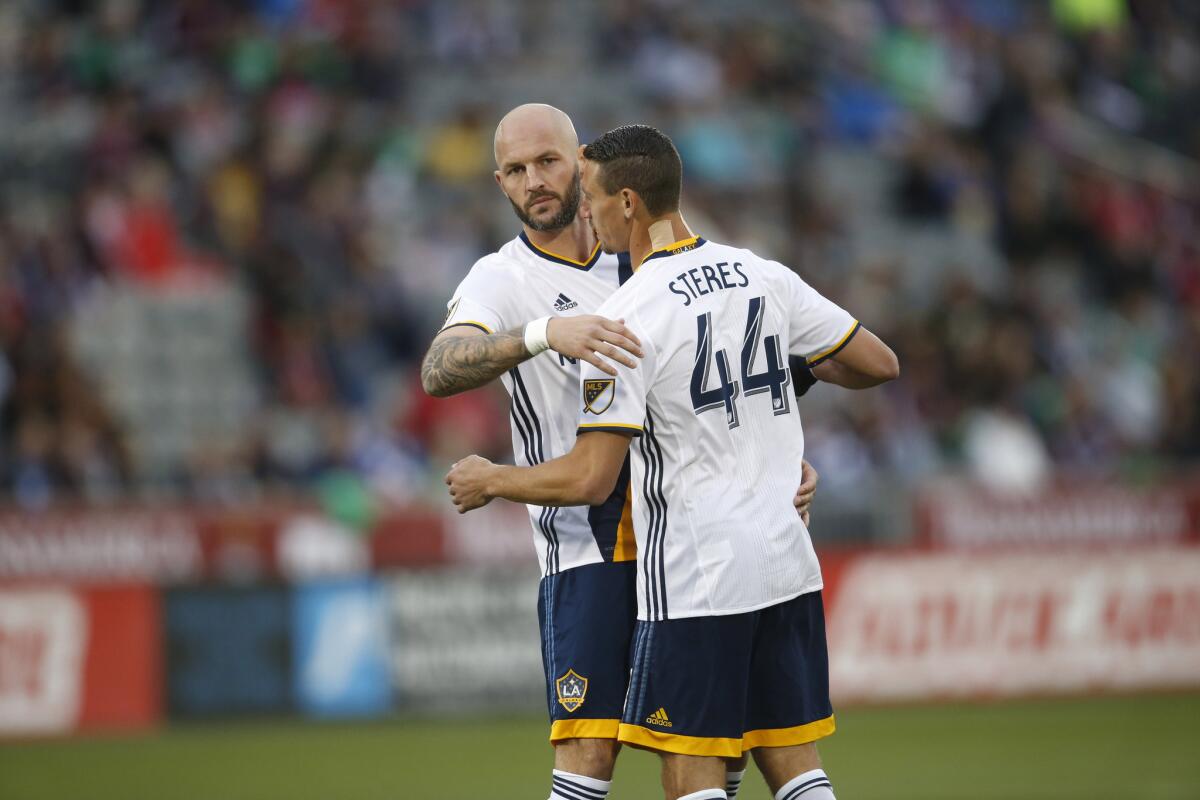 Galaxy defenders Jelle Van Damme (37) and Daniel Steres (44) talk during the first half of a match on March 12.