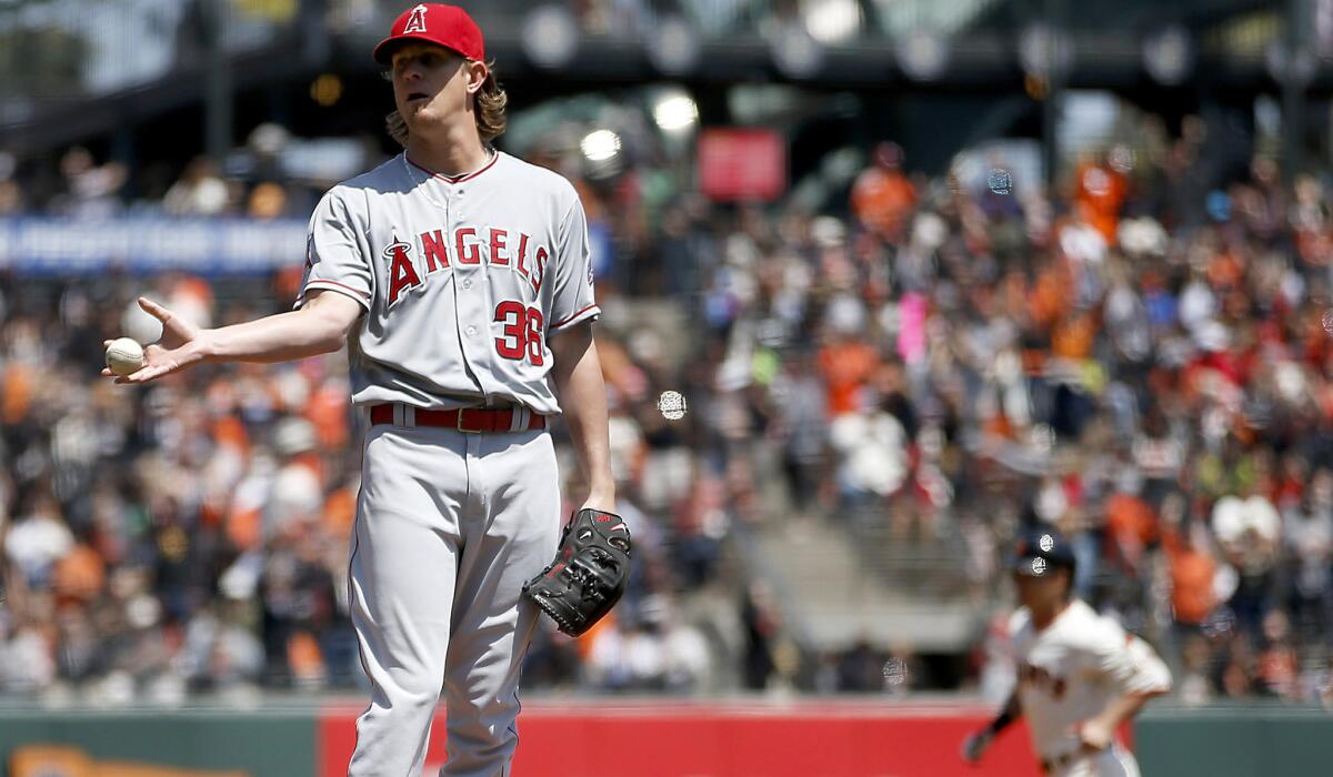 Angels starting pitcher Jered Weaver gave up a leadoff home run to Giants left fielder Nori Aoki (background). He then gave up a home run to Joe Panik in the next at-bat.